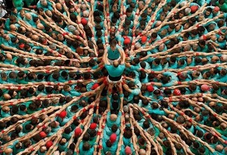 Castellers de Vilafranca start to form a human tower called  castell  during a biannual competition in Tarragona city